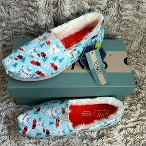 Toms blue yeti faux fur slip ons. New with tags. Women’s size 5.5. Never worn